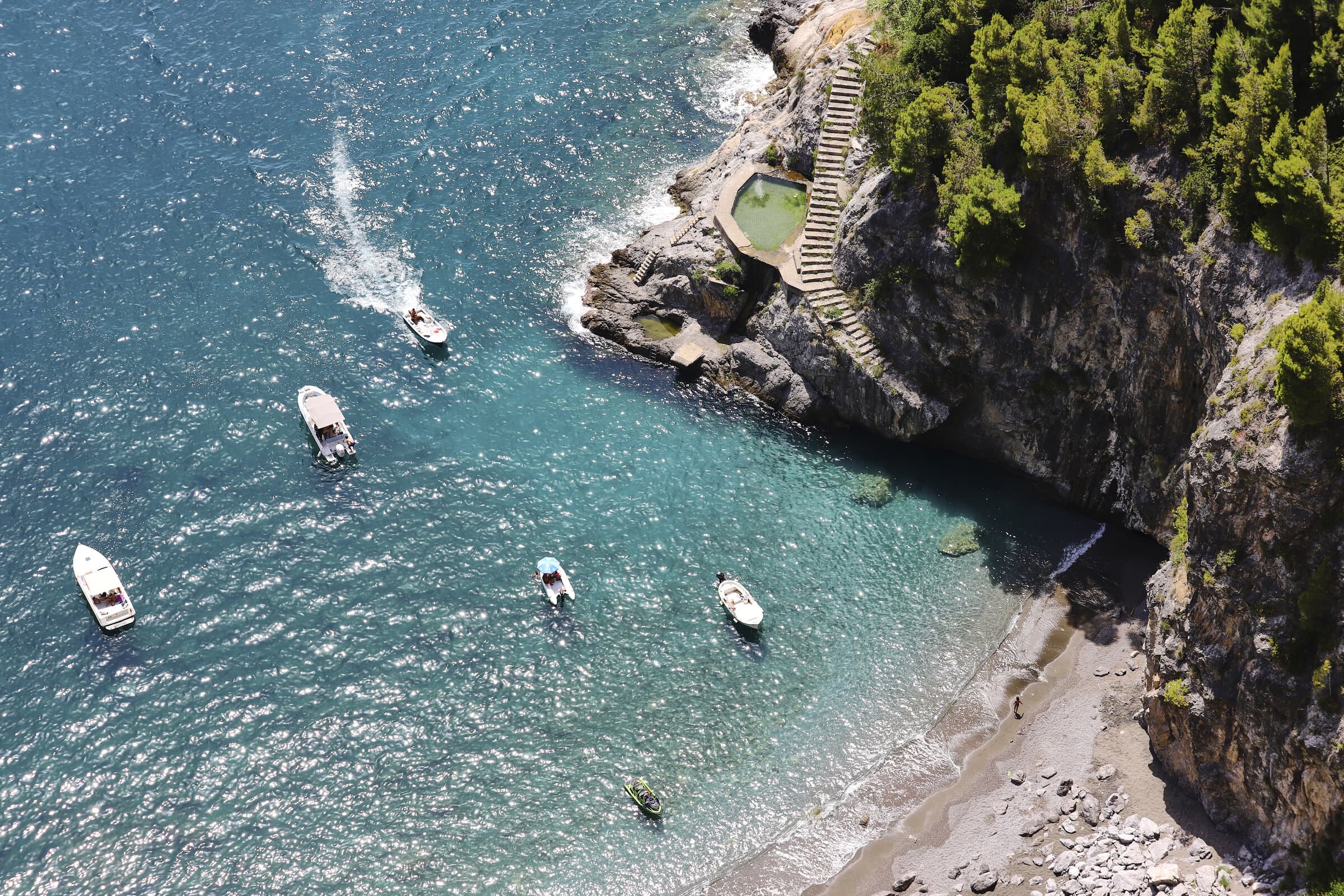 Boats in turquoise waters along the Amalfi Coast