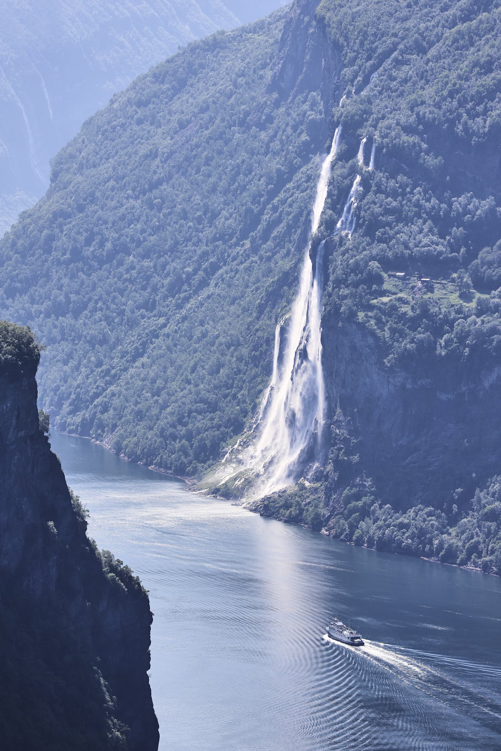 Waterfall cascading into a Norwegian fjord
