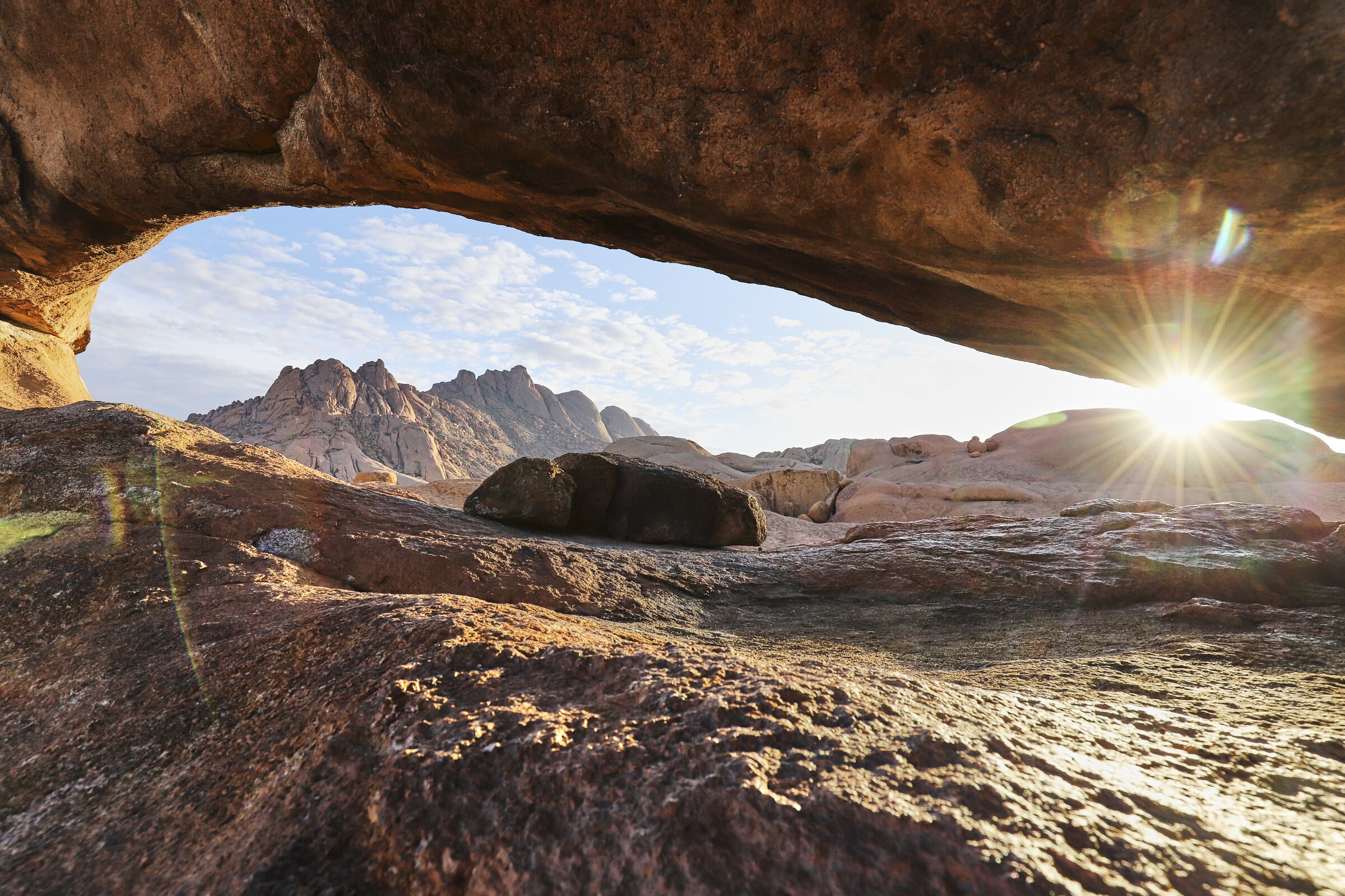 Sunlight through a desert rock arch