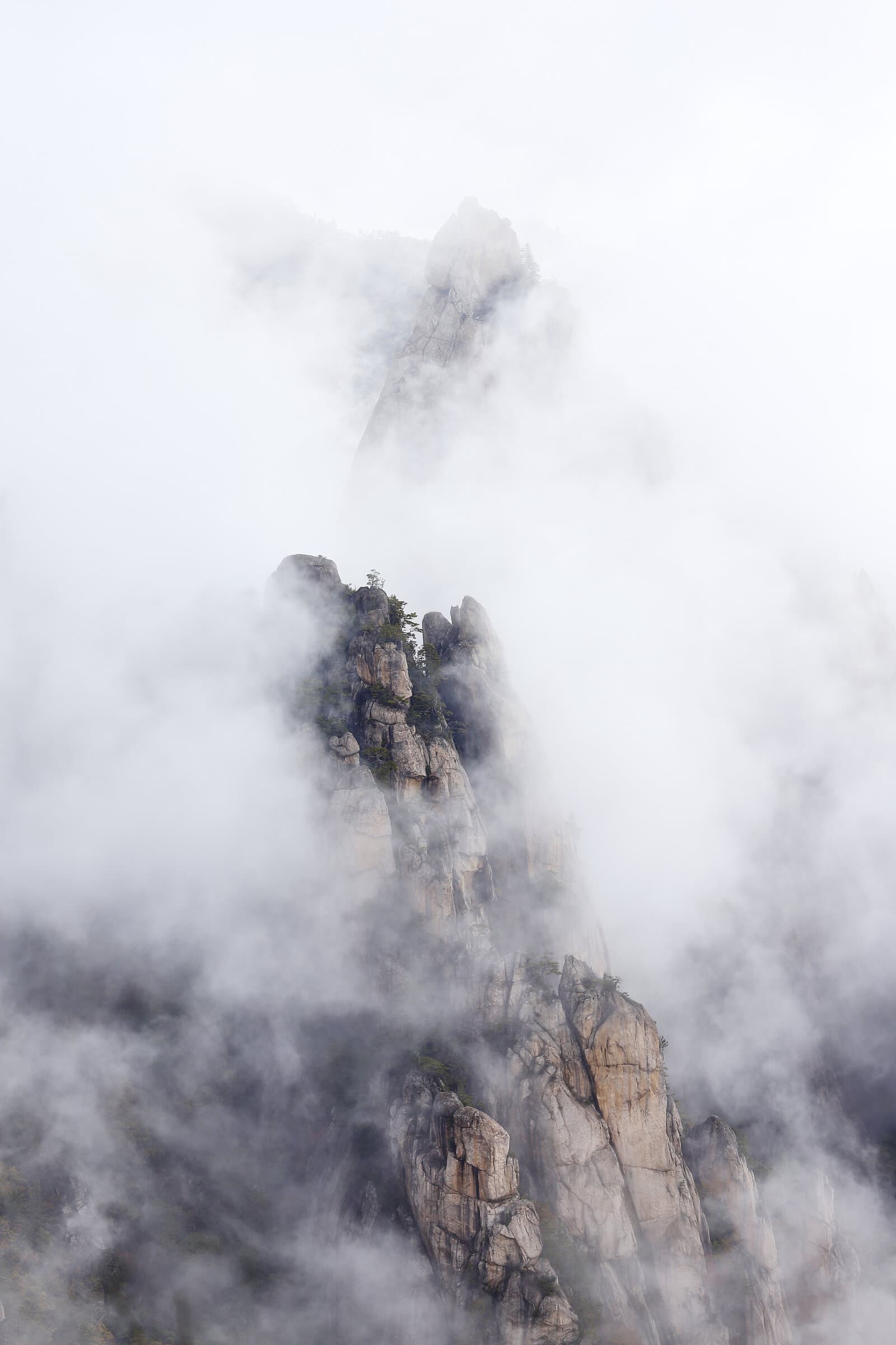 Granite pillars emerging from clouds