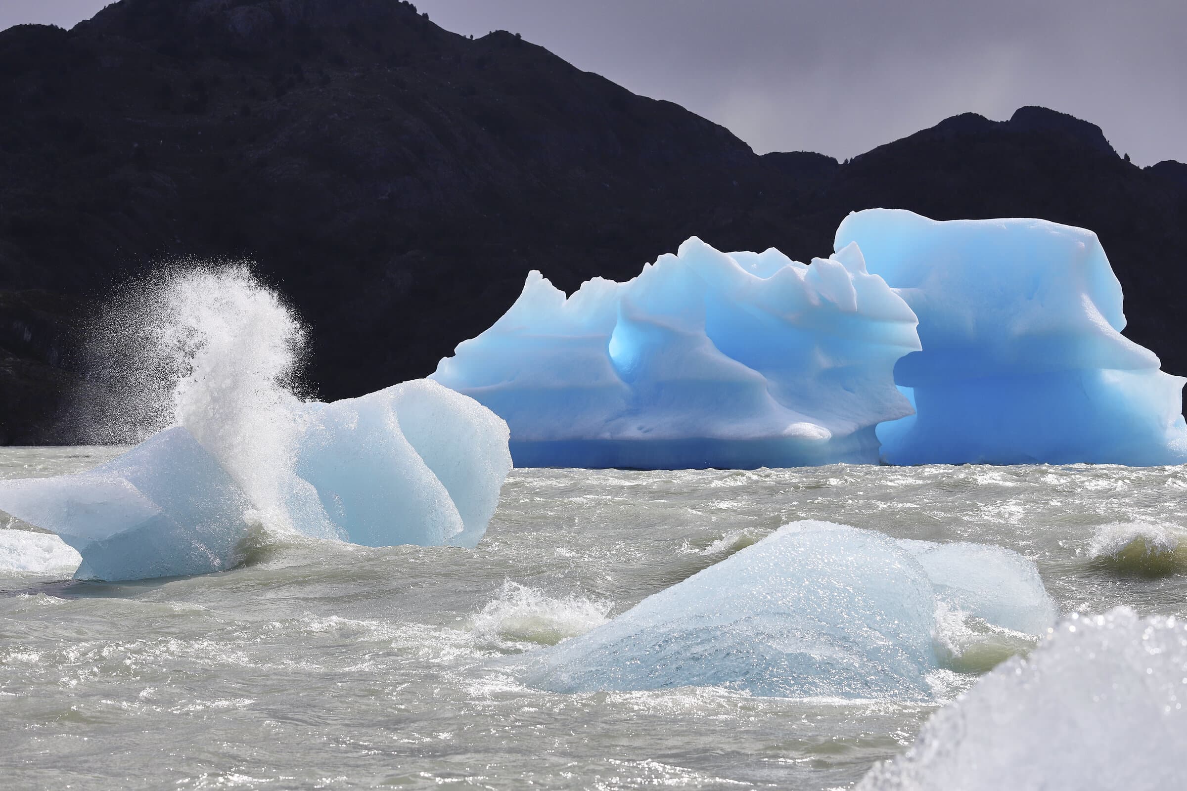 Blue icebergs in choppy waters